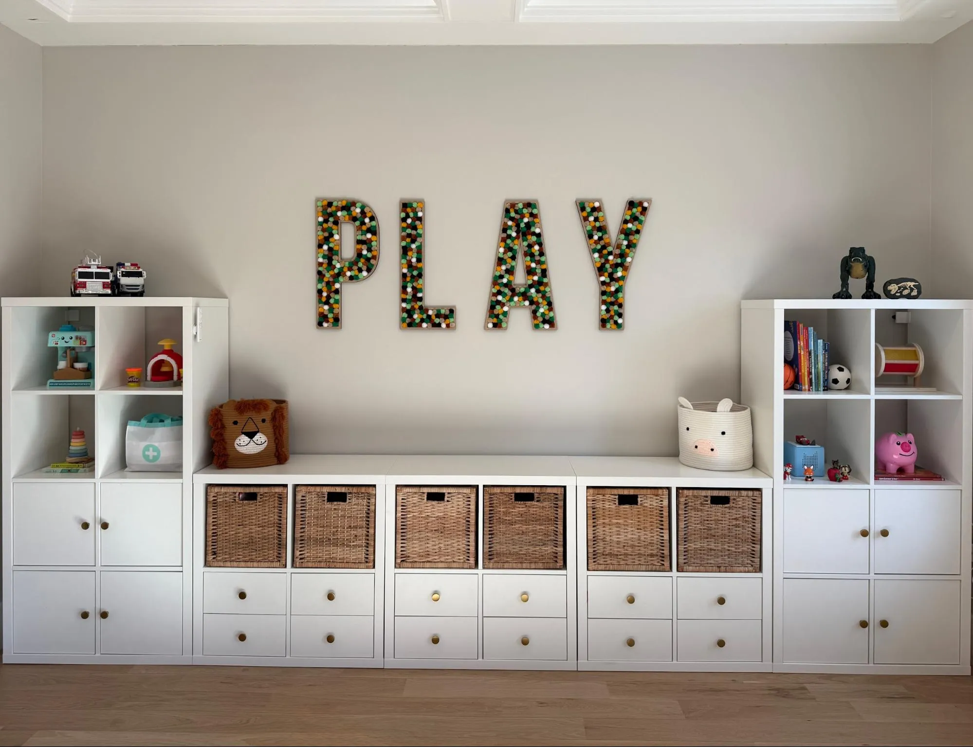 Organized playroom with white storage cubbies and woven baskets